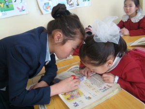 Erdenetuul tutoring a girl in the primary school.